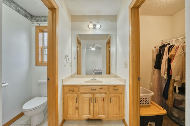 bathroom with tile patterned floors, toilet, and vanity