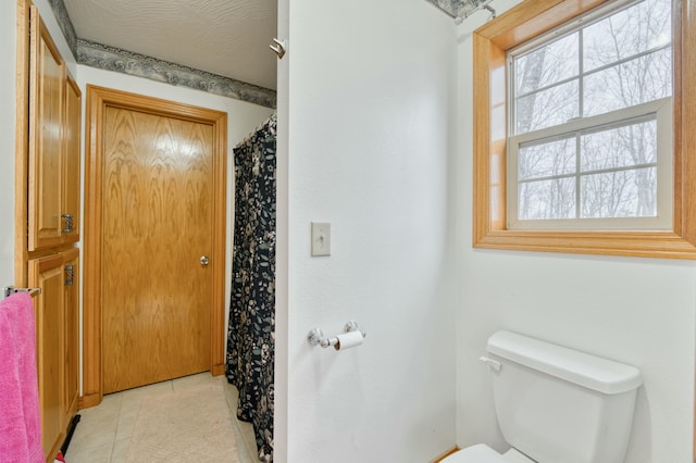 bathroom with tile patterned floors and toilet