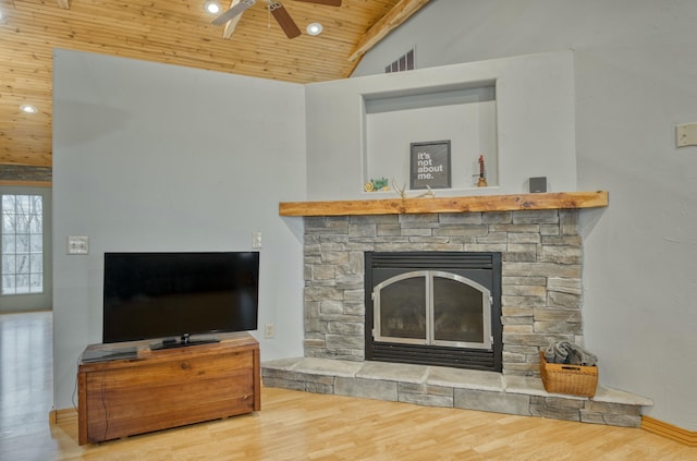 living room with a stone fireplace, lofted ceiling, hardwood / wood-style flooring, ceiling fan, and wooden ceiling