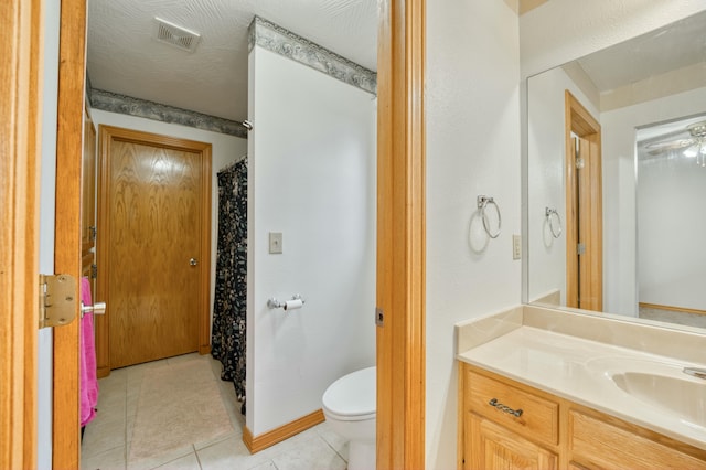 bathroom featuring vanity, toilet, and tile patterned flooring