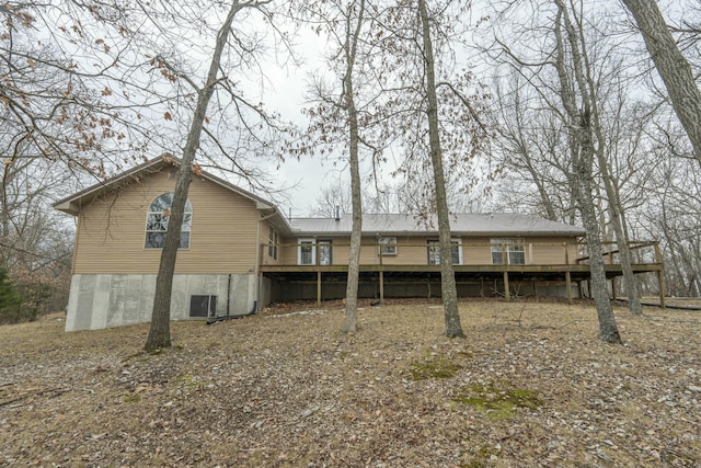 rear view of house featuring a deck