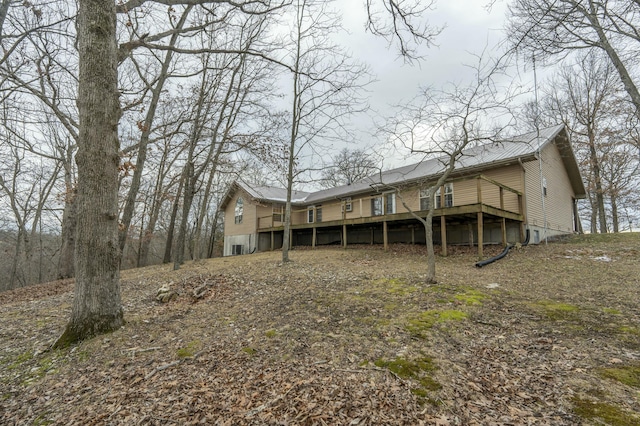 rear view of house featuring a wooden deck