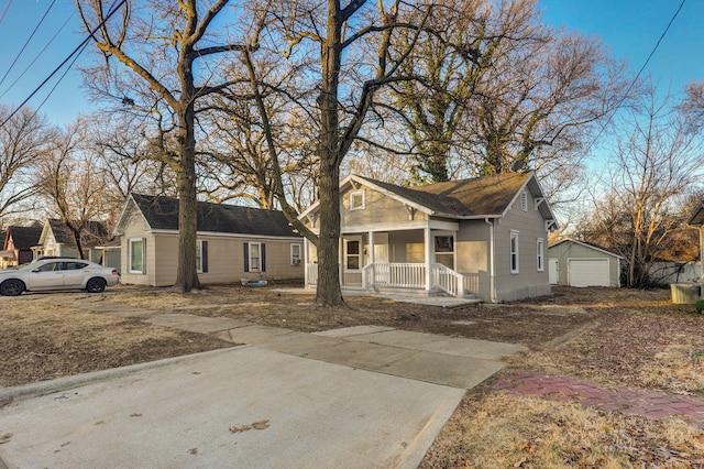 view of front facade with an outbuilding, a porch, and a garage