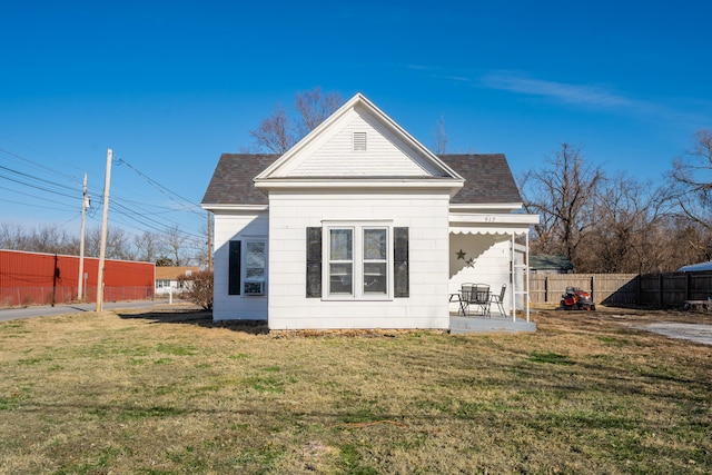 rear view of house with a lawn