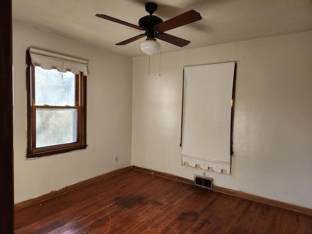 unfurnished room with dark hardwood / wood-style flooring and ceiling fan