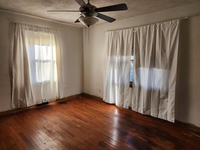 unfurnished room with ceiling fan and wood-type flooring