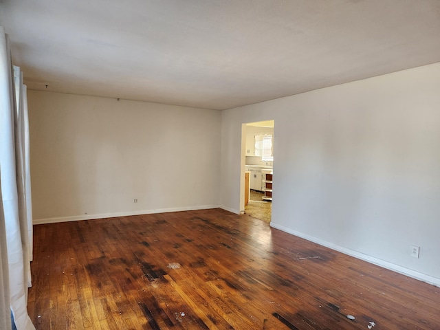 empty room with dark hardwood / wood-style flooring