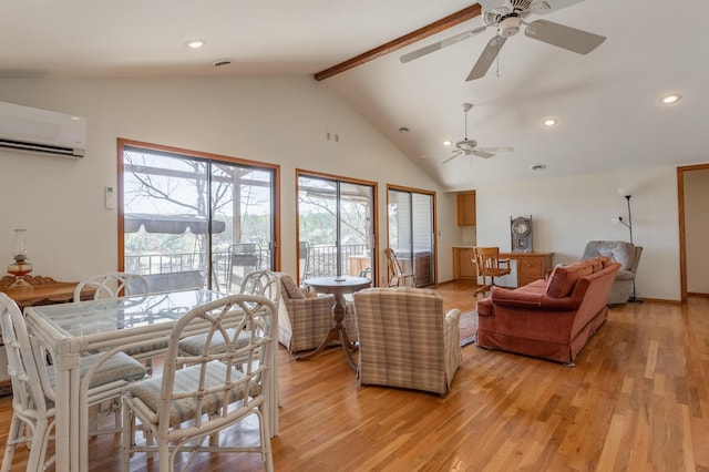 living room featuring a wall mounted air conditioner, lofted ceiling with beams, and light wood-type flooring