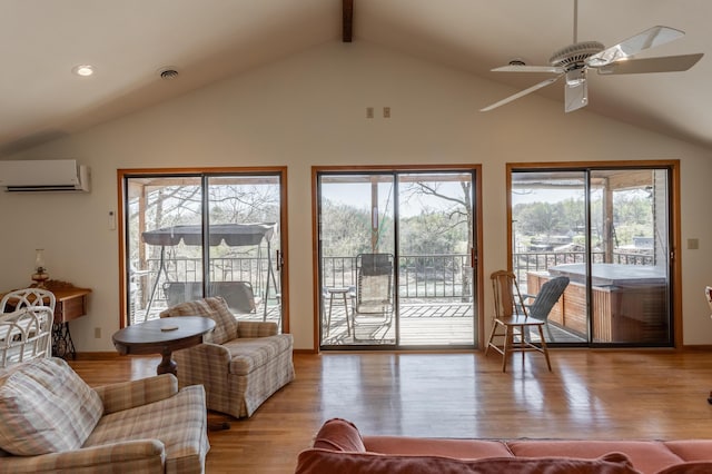 living room with ceiling fan, a wall mounted air conditioner, light hardwood / wood-style flooring, and vaulted ceiling with beams