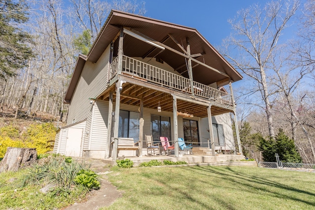 back of property with a yard, a patio area, and ceiling fan