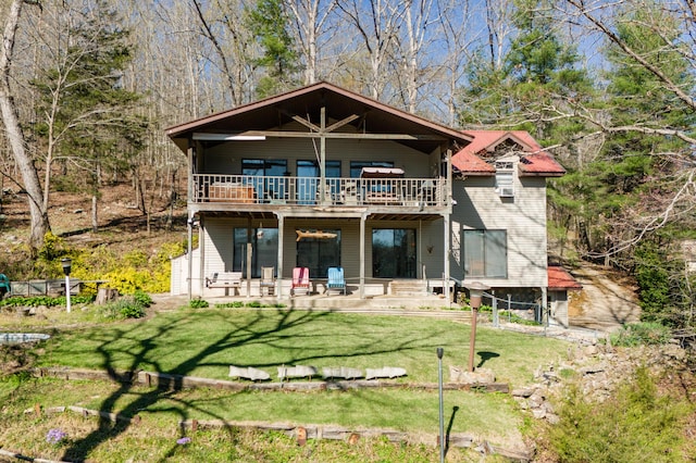 back of property with a patio and a lawn