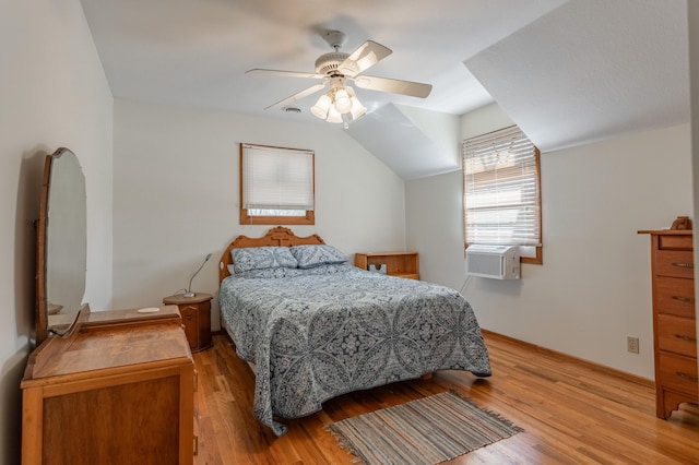 bedroom with lofted ceiling, cooling unit, ceiling fan, and light hardwood / wood-style floors