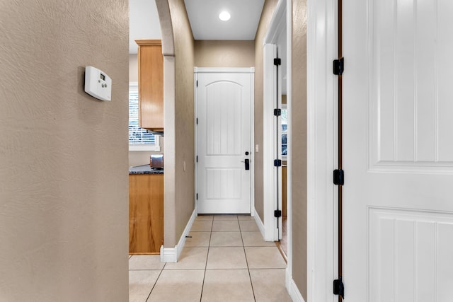 corridor featuring light tile patterned flooring