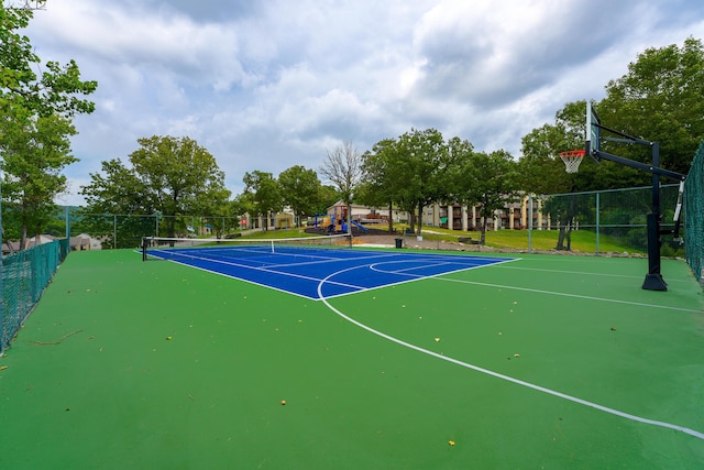 view of basketball court with tennis court and a playground