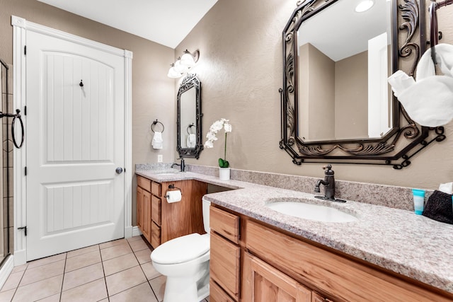 bathroom featuring tile patterned floors, toilet, and vanity