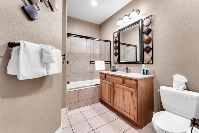 full bathroom featuring vanity, toilet, tiled shower / bath combo, and tile patterned flooring