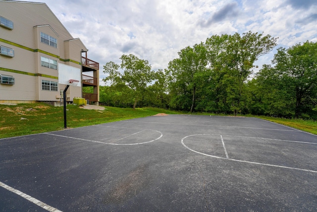 view of sport court with a yard