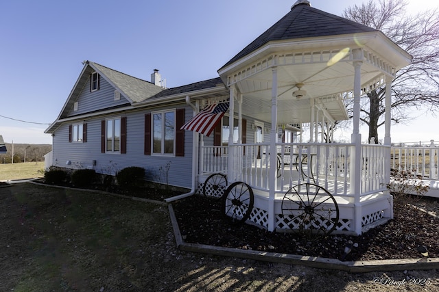 back of property with covered porch