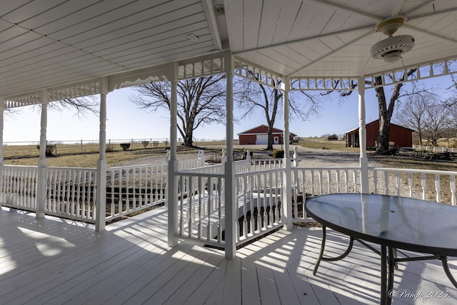 wooden deck featuring a gazebo and ceiling fan