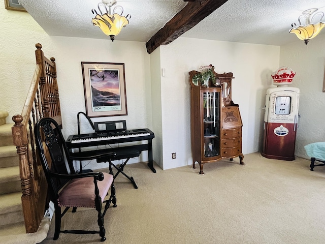 miscellaneous room featuring beamed ceiling, carpet flooring, and a textured ceiling