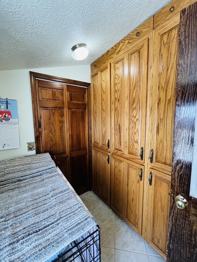 tiled bedroom with lofted ceiling and a textured ceiling