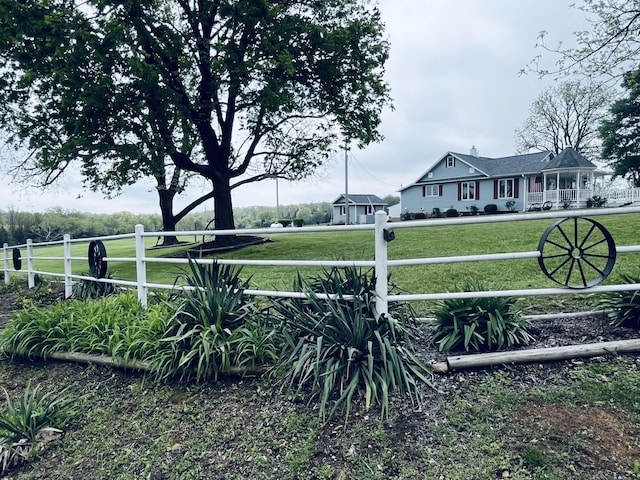 view of home's community featuring fence private yard and a lawn