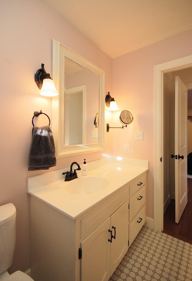 bathroom featuring vanity and toilet