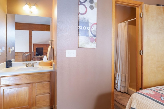 bathroom featuring walk in shower and vanity