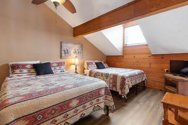 bedroom with lofted ceiling with beams, hardwood / wood-style floors, ceiling fan, and wood walls