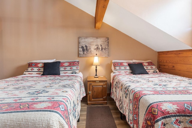 bedroom with dark wood-type flooring and lofted ceiling with beams