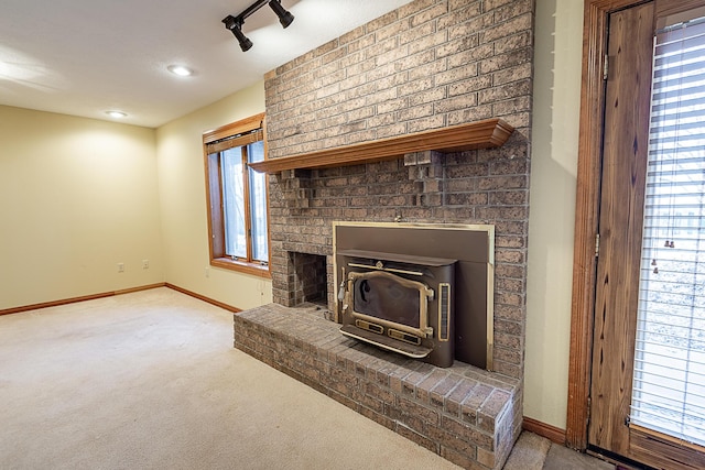 unfurnished living room with track lighting and light colored carpet