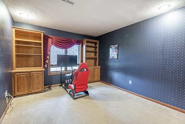 interior space with light colored carpet and a textured ceiling