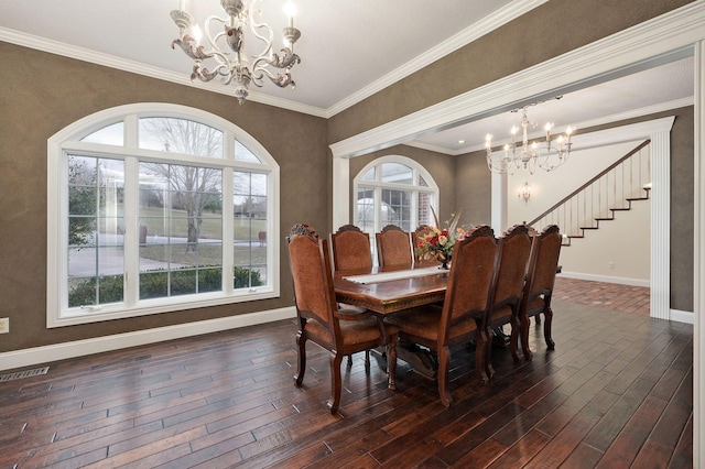 dining area with crown molding, a wealth of natural light, and a notable chandelier