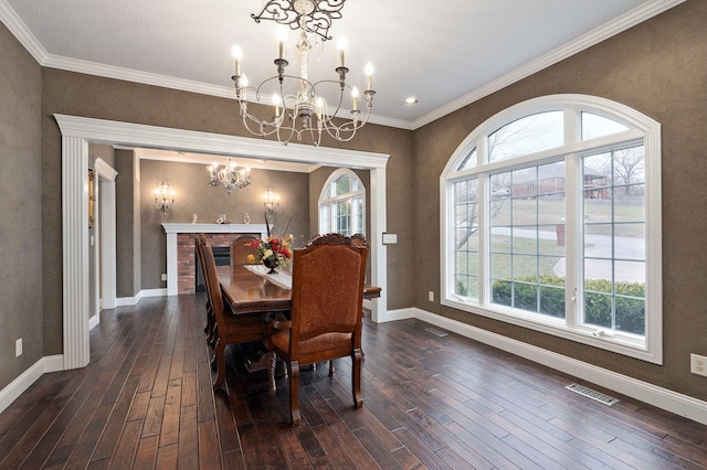 dining area with dark hardwood / wood-style floors, a wealth of natural light, and a notable chandelier