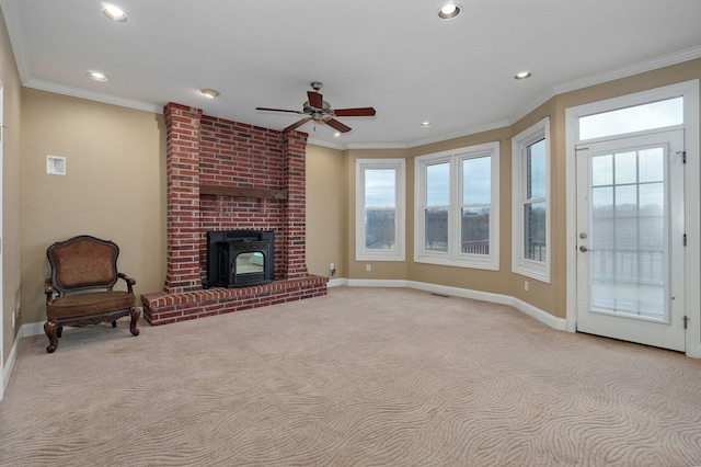 carpeted living room featuring a brick fireplace, ornamental molding, and a healthy amount of sunlight