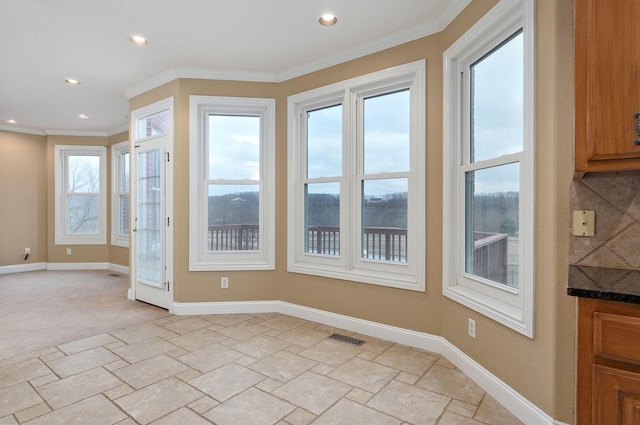 interior space with crown molding and light colored carpet