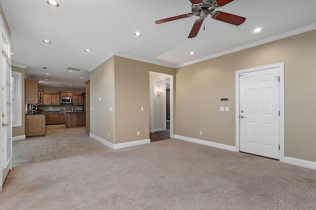 unfurnished living room featuring light carpet, ornamental molding, and ceiling fan