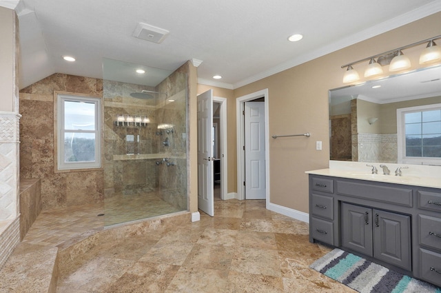 bathroom featuring crown molding, tiled shower, and vanity