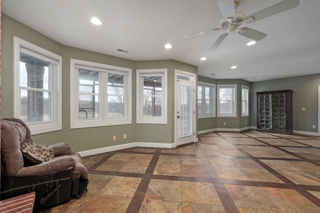 interior space featuring tile patterned flooring and ceiling fan