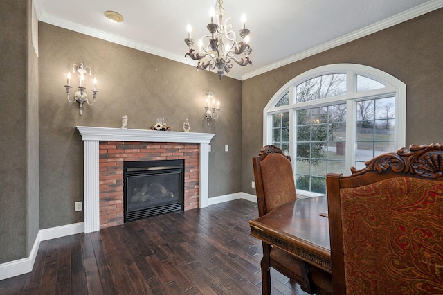 dining area featuring a fireplace, ornamental molding, dark hardwood / wood-style floors, and a notable chandelier