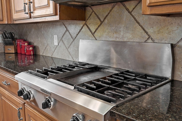 room details featuring backsplash and stainless steel gas stovetop