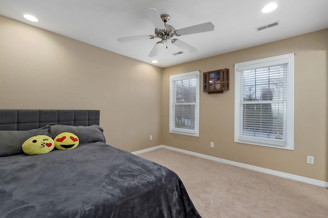 bedroom featuring light carpet and ceiling fan