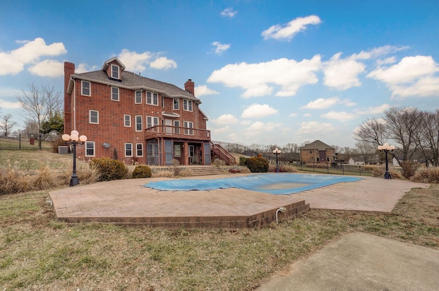 view of swimming pool with a patio, a deck, and a lawn