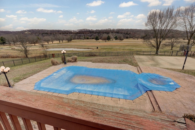 view of swimming pool featuring a rural view and a patio area