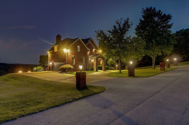 view of front of property with a garage and a front lawn