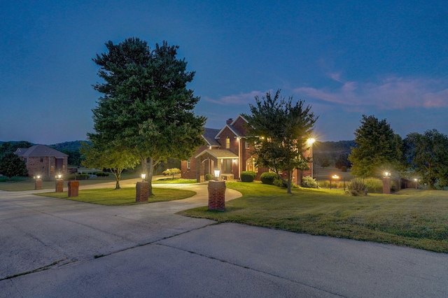 obstructed view of property with a yard