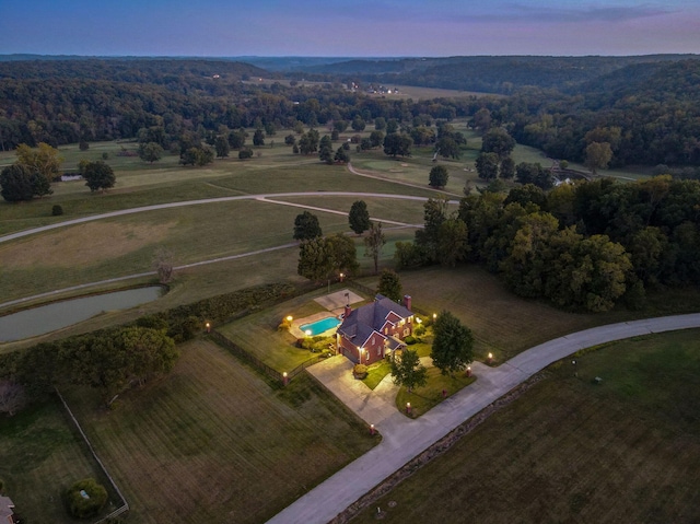 aerial view at dusk featuring a rural view