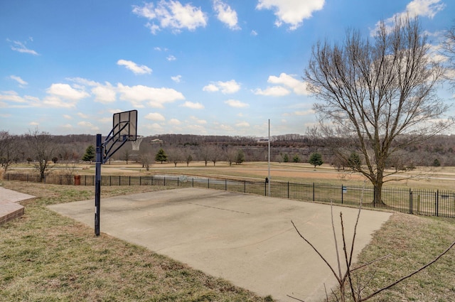 view of basketball court featuring a yard and a rural view