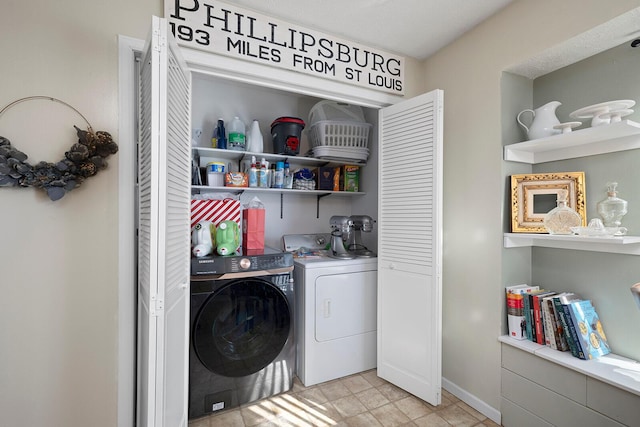 laundry area featuring washing machine and clothes dryer