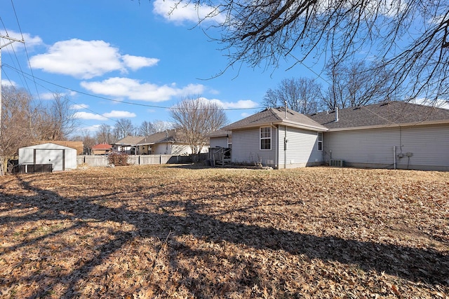 view of side of home with a storage shed